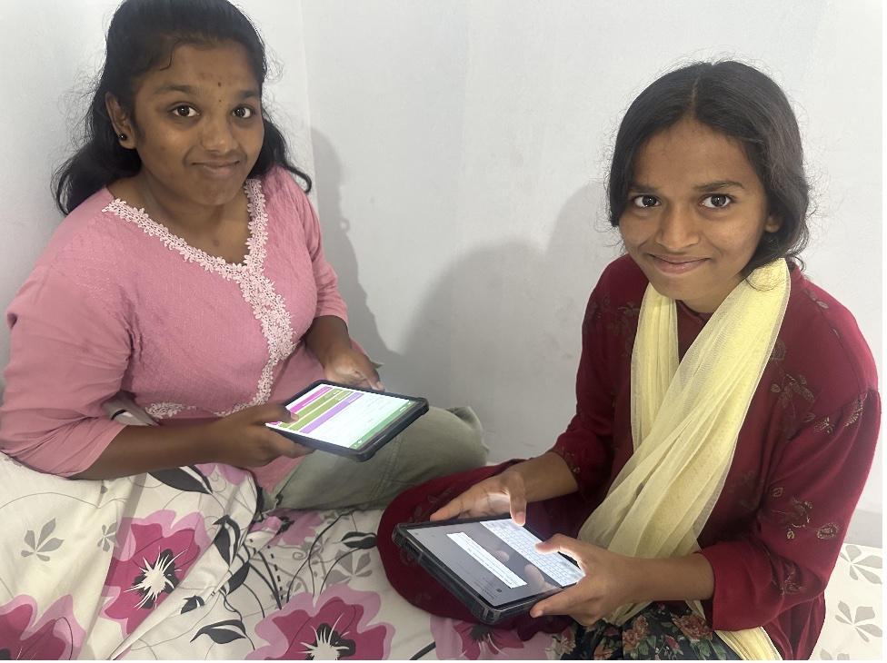 Children using LearnOS tablets at Basera
